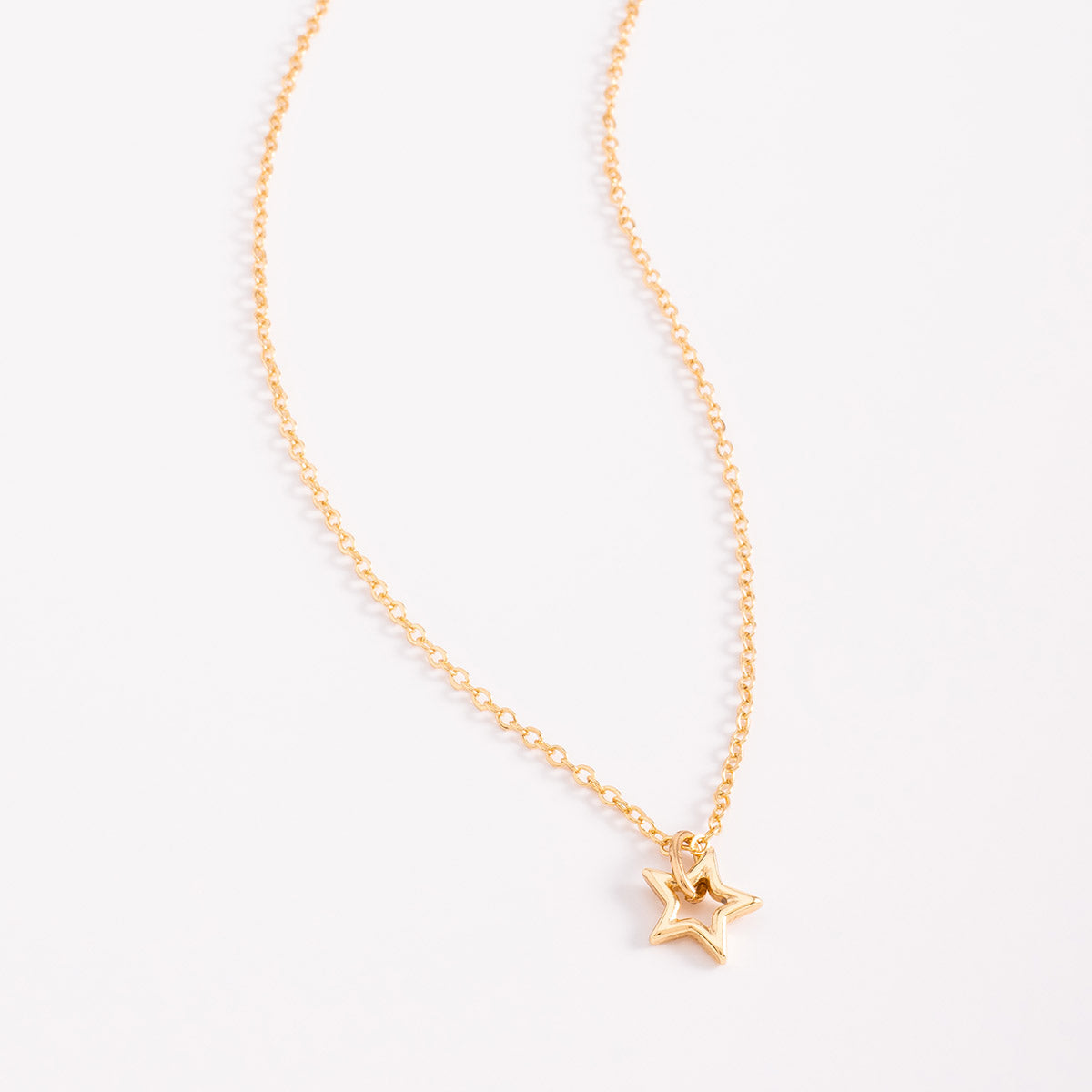 Collar en baño de oro con dije estrella hueca moderna